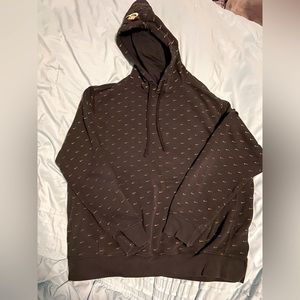 XL black Nike hoodie with little gold Nike swooshes all over it.
